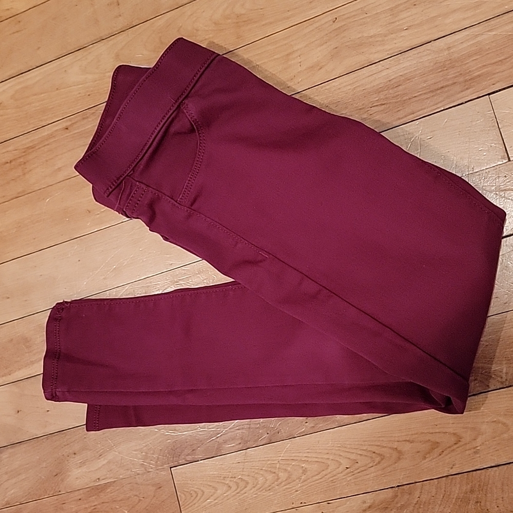 Burgundy jeggings.